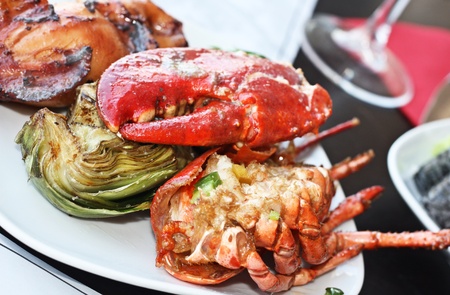 Close up of roasted lobster with artichokes の写真素材