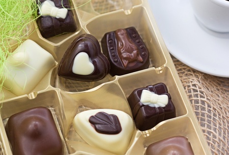 The golden box of sweets and coffee cup 