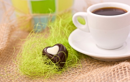 Coffee in white cup and chocolate- heart の写真素材