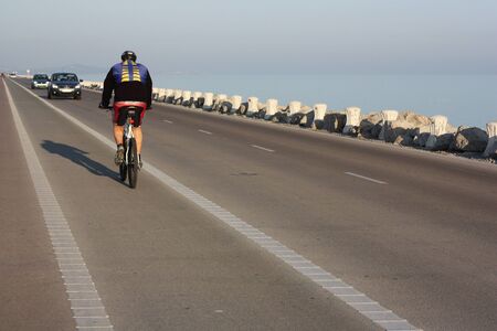 Cyclist on the coastal road の写真素材
