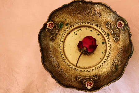 Antique plate with a rose insideの写真素材