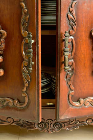 Woody antique cabinet with the plates insideの写真素材