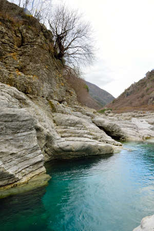 Very Particular white river rocks carved by decades of water turquesの写真素材