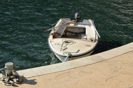Small white boat in the harbor