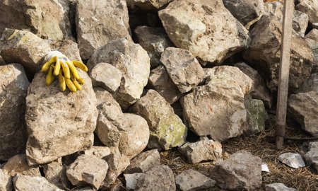 Pair of gloves mason leaning on the stonesの写真素材