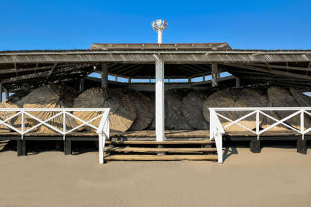 The straw umbrellas waiting for the summerのeditorial素材