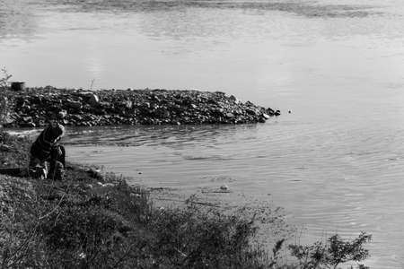 Old fisherman on the banks of the riverの写真素材