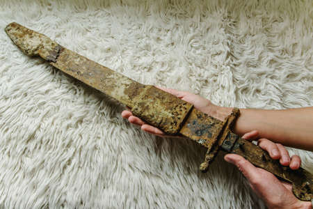Laying the antique real sword on a handmade wool blanketの写真素材