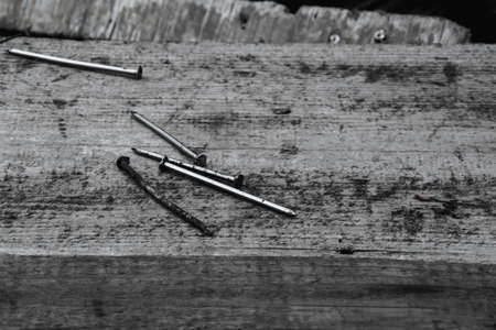 Nails on a grunge wooden surfaceの写真素材