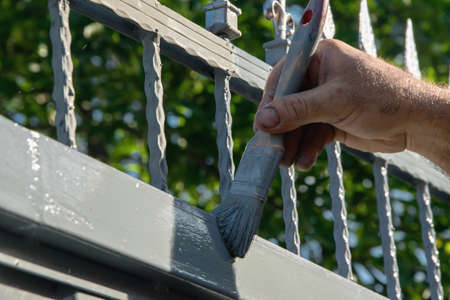 Painting the door in the gardenの写真素材