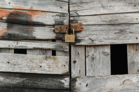 Old wooden door closing with claspの写真素材