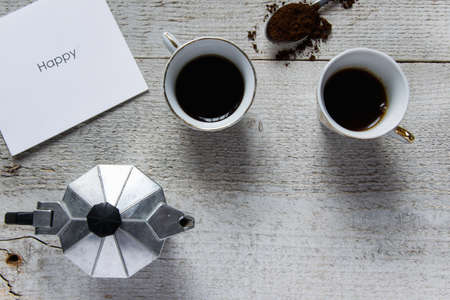 Happy coffee time. Italian coffee maker - moka and white card with "Happy" textの写真素材