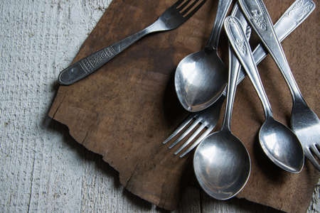 Detail of vintage cutlery on wooden tableの写真素材