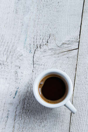 Top view of coffee cup on wooden backgroundの写真素材