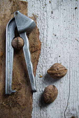 Rustic view of nutcracker and walnuts on wooden background. Healthy eating conceptの写真素材