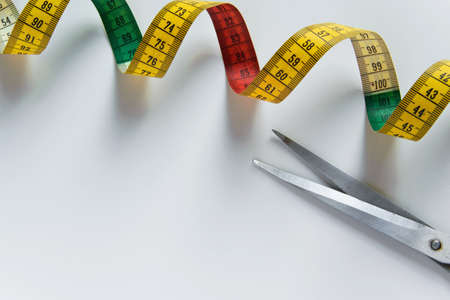 Isolated sewing meter and scissors on white background with space for text. Concepts - tialor, fashionの写真素材