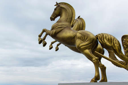 Bronze statue of two horses in motion with sky and space for textの写真素材