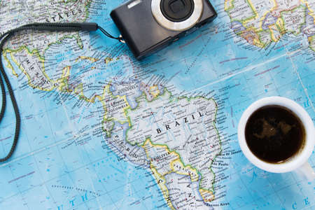 Top view of adventure flat lay with coffee cup and camera. Explore the new world or planing the vacationの写真素材