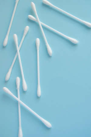 Sanitary themes - cotton sticks on blue background with space for text. Hygienic, medical concept