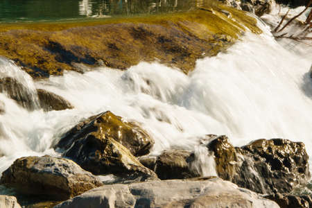 Natural background of flowing water in the golden riverの写真素材