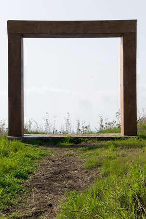 Abstract wooden doorway / entrance in the meadowの写真素材