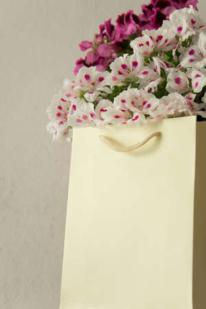 Beautiful fresh flowers in the paper bag - decoration, gift concept. Space for textの写真素材