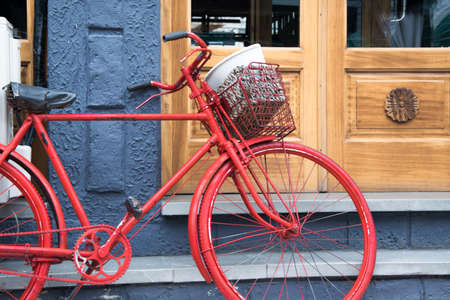 Old bicycle in front of the house door, traditional mode of transportation for healthy lifeの写真素材