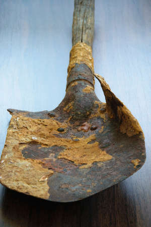 Isolated damaged antique military shovel