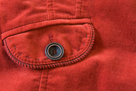 Close up view of pocket of old-fashioned red velvet jacket