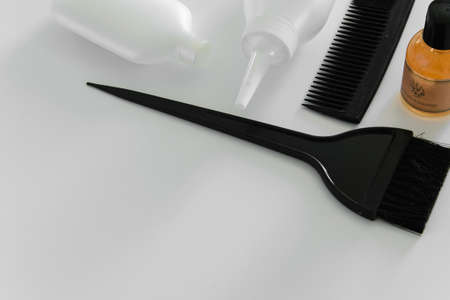 Hair dye tools on white background, space for text
