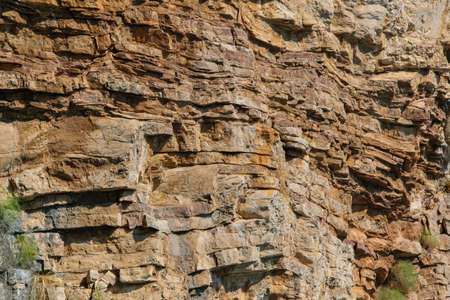 Natural background of solid rough stone wall