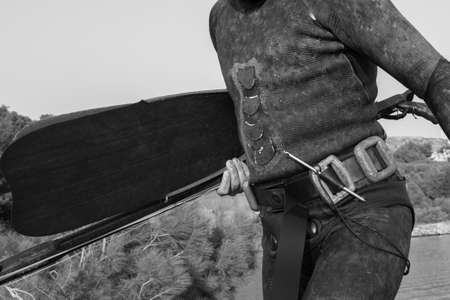 Crop view of scuba diver adult man on a seashore with spearfishing gear (fins, speargun), space for textの写真素材