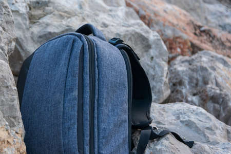 Close up of backpack on stone background, space for text. Adventure traveler concept, sport equipmentの写真素材