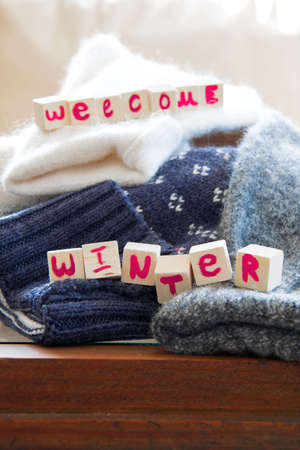 Crop view of woolen sweaters with "Winter mood ON" text, fashion seasonal conceptの写真素材