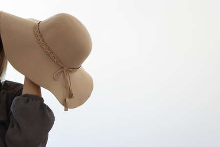 Elegant woman in hat on white background, space for textの写真素材