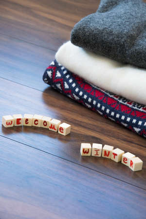 Crop view of woolen sweaters with "Welcome Winter" text, fashion seasonal conceptの写真素材