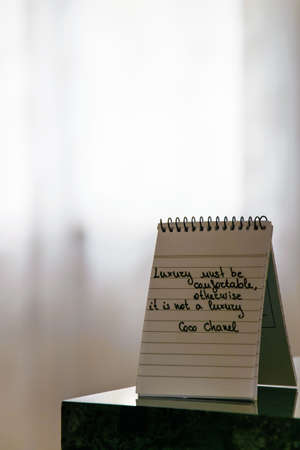 Coco Chanel quotes written on a block note, inspiration phrase Luxury must be comfortable, otherwise...