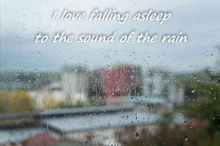 Rain drops on window with text - I love falling asleep to the sound of rain