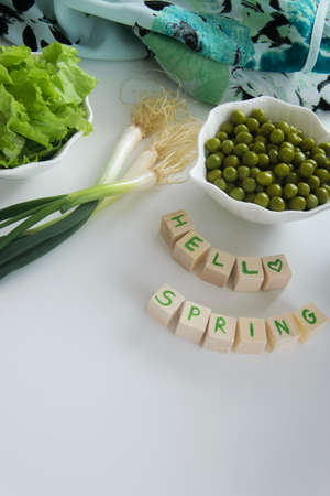 Fresh raw spring vegetables on white background, text  Hello spring