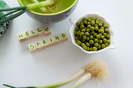 Fresh raw spring vegetables on white background, text " Hello spring"の写真素材