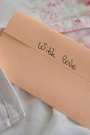Pastel color envelope on a silky cloth, romantic love concept
