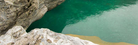 Areal view  of pure turquoise river water and white rocks. Natural background with space for text