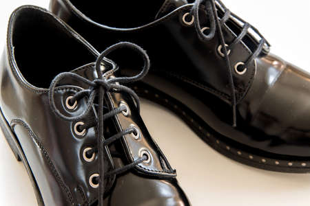 Isolated classic pair of black shoes on white background, fashionable evergreen footwearの写真素材