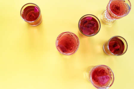 Close up view of rose refreshment drinks on yellow background