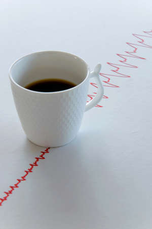 Coffee cup with electrocardiogram lines on white backgroundの写真素材