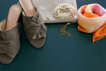 Top view of fashion female flat lay on deep green background