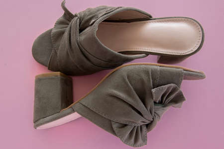 Pair of mules/clogs (military green color) on pink backgroundの写真素材