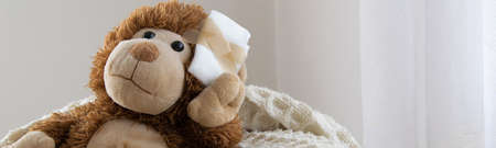 Teddy Bear toy wounded in the head. Accident, healthcare conceptの写真素材