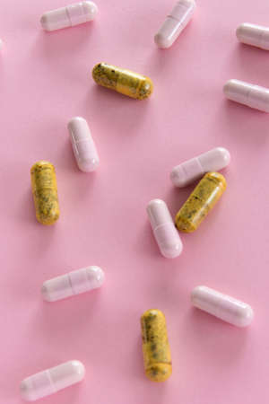 Different medication pills on pink background. Healthcare, medical conceptの写真素材