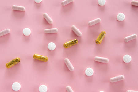 Different medication pills on pink background. Healthcare, medical conceptの写真素材